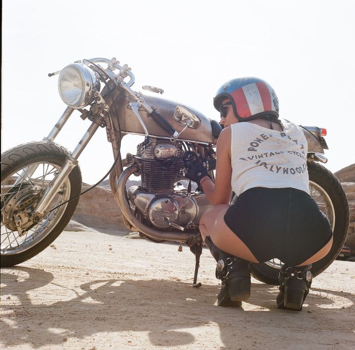 A playful frame from Girls on a motorcycle — online in Bern